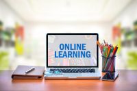 photo of a laptop with the words "online learning" on its monitor
