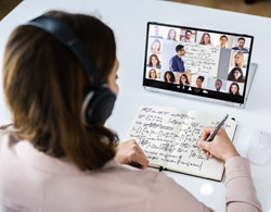 A person at home attends a virtual webinar with hybrid audience